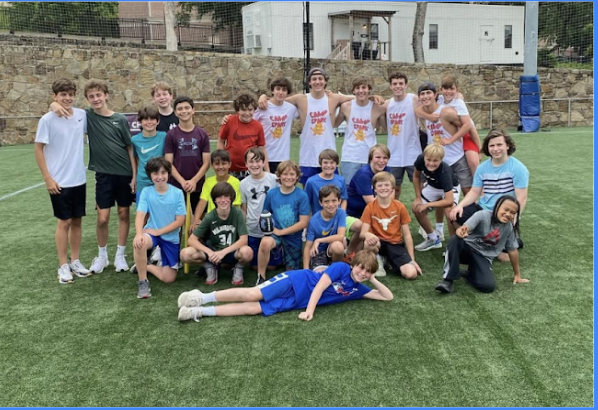 Camp Spark counselors and campers group photo on the field